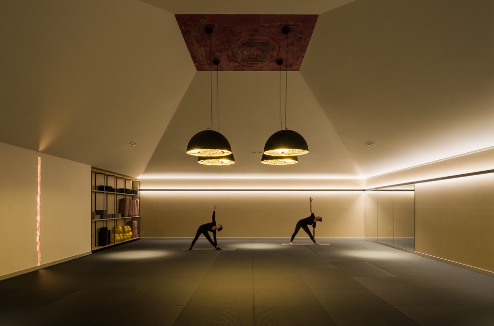 A calm yoga studio at Flow in Christchurch with a rug set into the raised ceiling