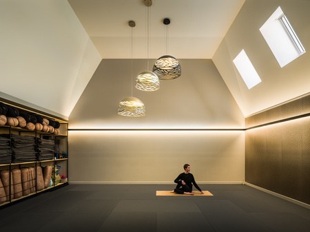 Serene yoga practice room at Flow, Christchurch, with sculptural pendants and layered lighting