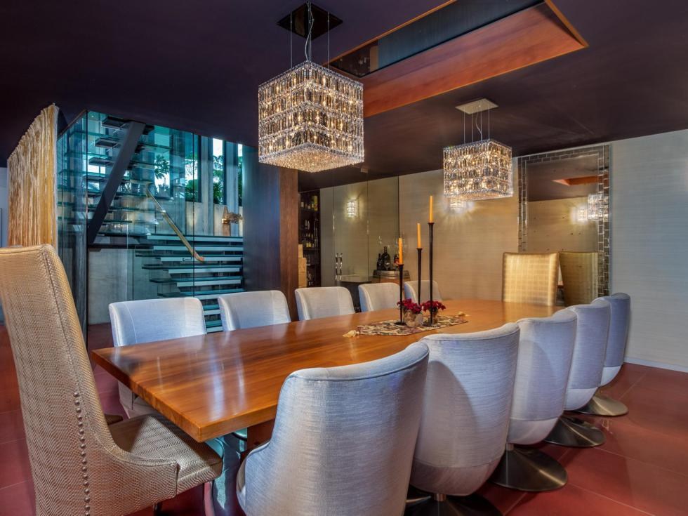 Formal dining room with twin crystal chandeliers and a suspended glass staircase, Martins Bay